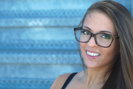 young woman face portrait space for text blue gray backgroundの写真素材