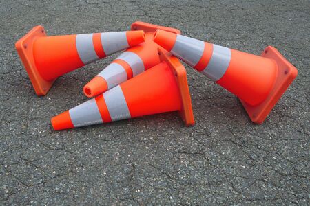orange traffic cones under construction asphalt roadの写真素材