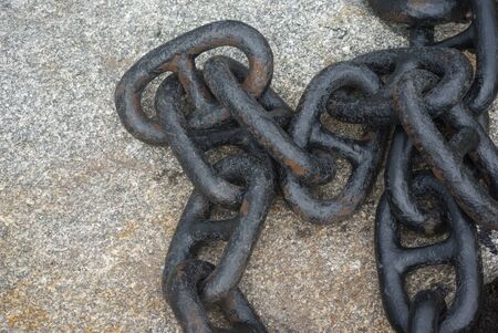 black rusted metal boat chain on concreteの写真素材