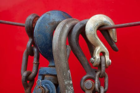 metal hooks on a cord red backgroundの写真素材