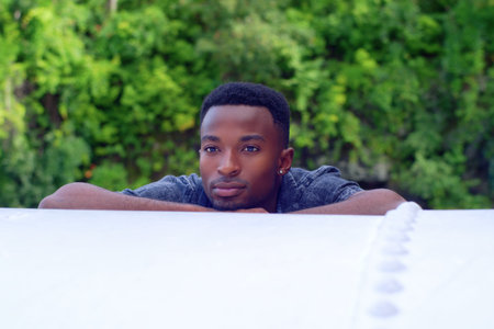 young man thinking outside daydreaming in nature
