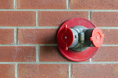 building sprinkler hose connection hydrant brick wall