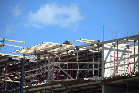 construction site worker building metal beams structureの写真素材