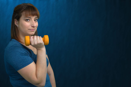 fitness for woman sport exercices dumbbells training room healty lifestyle blue background