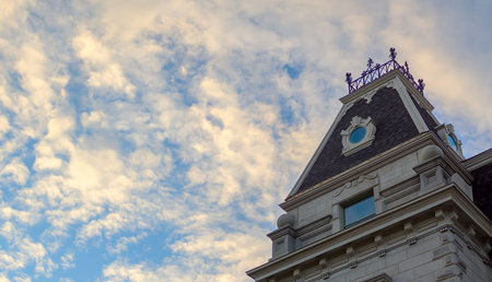 historical building on cloudy sky ancient architecture gray brick and metal roof