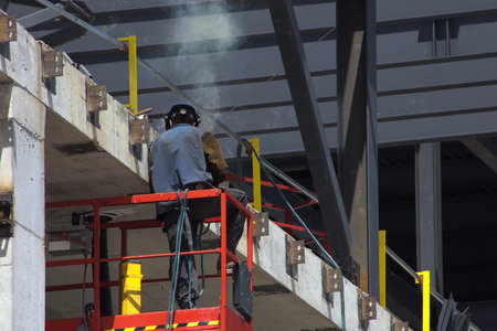 welder working on a concrete wall construction site worker building structure