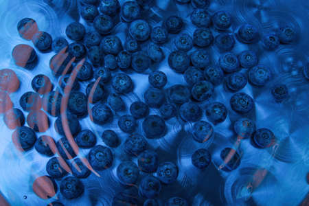 energy drink blueberries flavor whortleberry bilberry fruits in blue water aluminum can background berries juice close-upの写真素材
