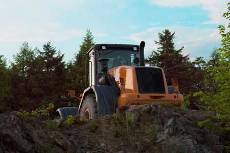 Heavy-duty yellow backhoe excavator at a construction site, carrying out earthmoving activities...