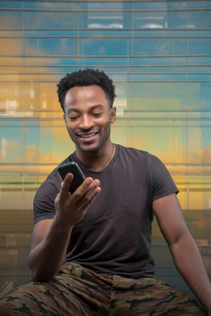 man browsing internet with his cellphone young african businessman holding telephone smiling on...