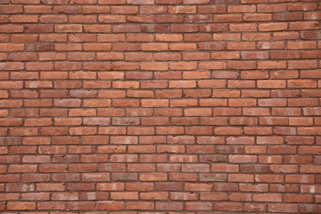 Red brick wall texture background with weathered bricks, cement joints, and an aged, grungy...