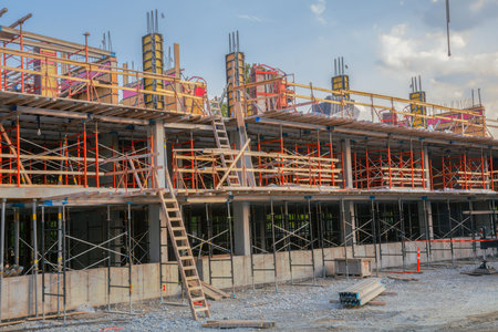 Active construction building showing residential development with concrete structure and...