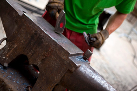 Ironworker working on an anvil in a studio