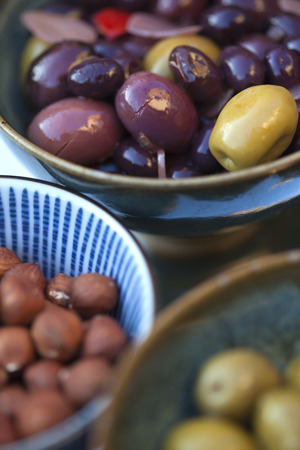 Olives and nuts in bowls for a buffetの写真素材