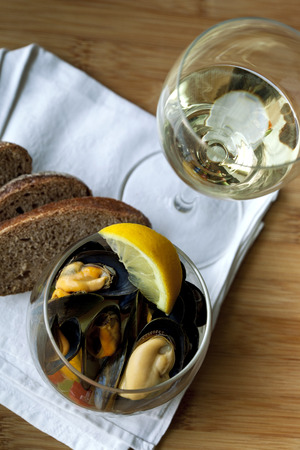 Mussels and glass of white wineの写真素材