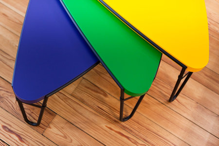 Stylish tables on a wooden floorの写真素材