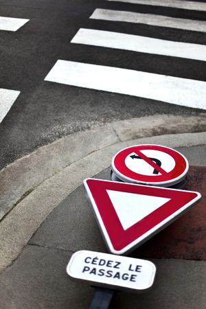 Road signs on a sidewalkの写真素材