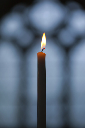 Flame of a candle in a churchの写真素材