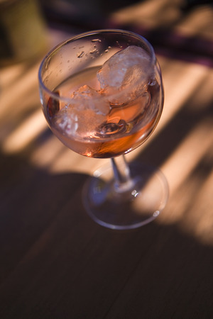 Glass of rose wine on a tableの写真素材