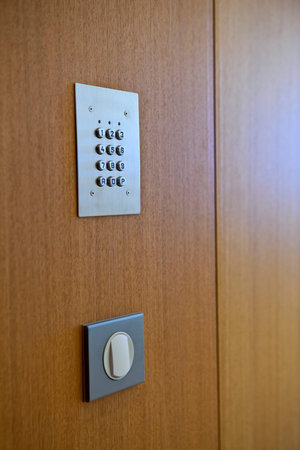 Digital code and switch on a wooden wall inside house