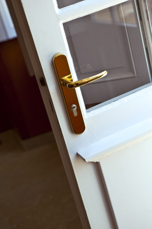 Focus on a brass door handle inside a houseの写真素材