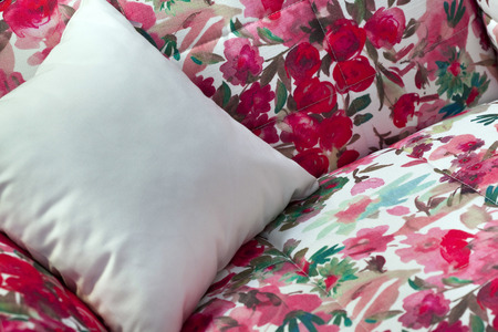 White cushion on a sofa with floral patternの写真素材