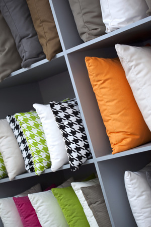 Close up of decorative cushions on wooden shelvesの写真素材