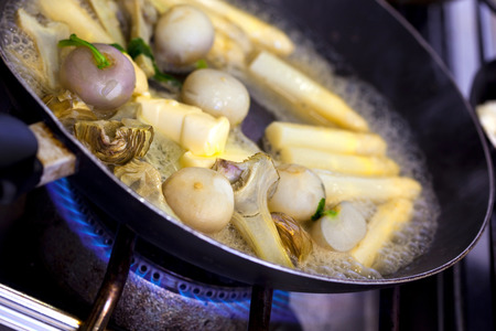 Cooking various vegetables and butter in a panの写真素材