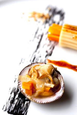 Shell, pasta and carrots on a plate, ink sauceの写真素材