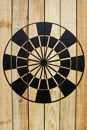 Black target painted on a wooden wallの写真素材