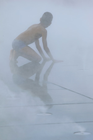 Silhouette of a young boy playing in the mystの写真素材