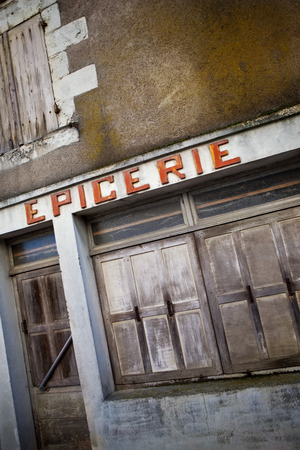Facade of an old abandoned grocery store in a French villageの写真素材