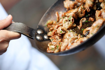 Cooking pork tripe and herbs in a panの写真素材