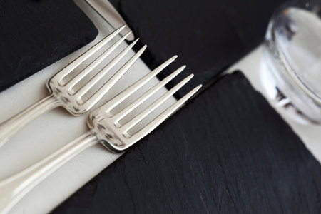 Forks and slates on a table set in a restaurant