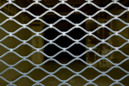 Close up of an old iron curtain of a closed storeの写真素材