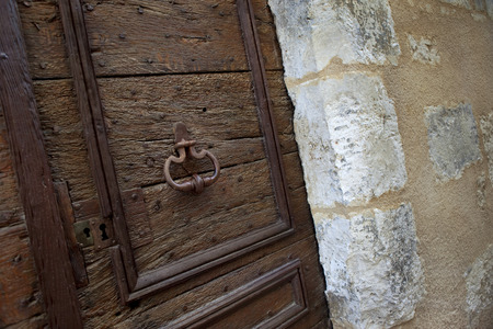 Wooden door on the facade of and old French mansion in a vullageの写真素材