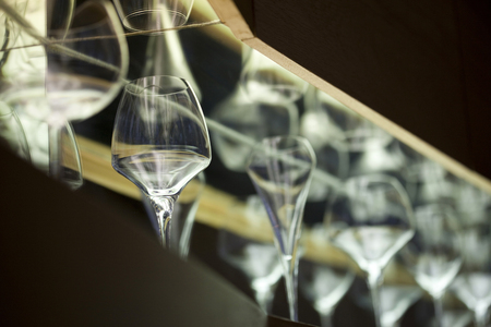 Glasses on shelves in a wine barの写真素材