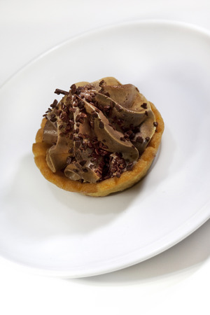 Close up of a chocolate cream cake on a plateの写真素材