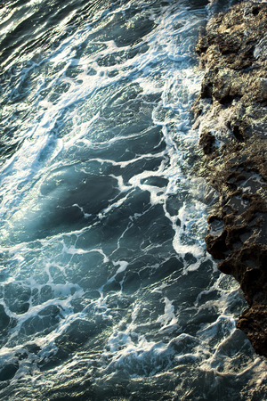 Rough sea against the rocks of the coast in Spainの写真素材