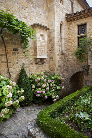 Charming garden of an old stoned house in Franceの写真素材