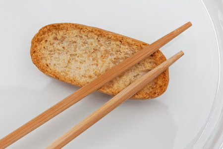 Crispy toast and chopsticks on a white plate