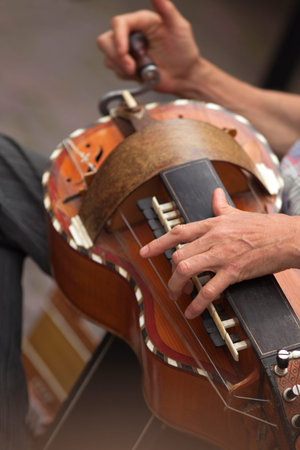 Playing old Britain musical instrument in a band