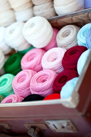 Spools of thread in an old suitcase on a flea market