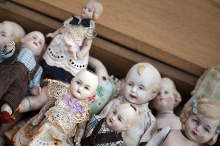 Vintage porcelain dolls on a flea market stallの写真素材