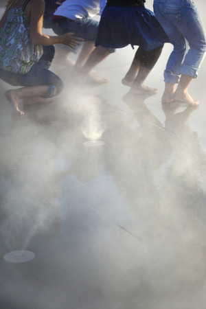 Group of young teens dancing in mistの写真素材