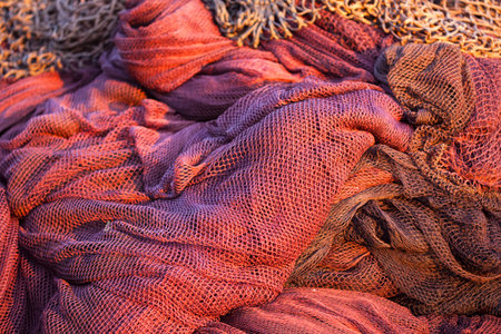 Background of red fishing nets on a portの写真素材