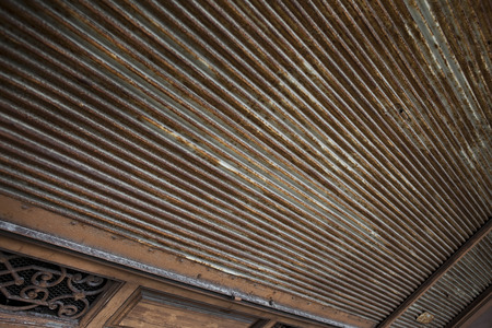 Old rusty iron curtain of a closed shopの写真素材