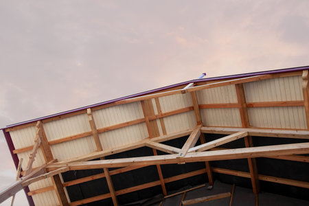 Low angle view of the frame of a house under constructionの写真素材