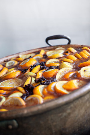 Cooking mulled wine with orangeの写真素材