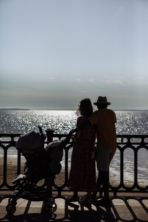Couple with baby looking out to seaの写真素材