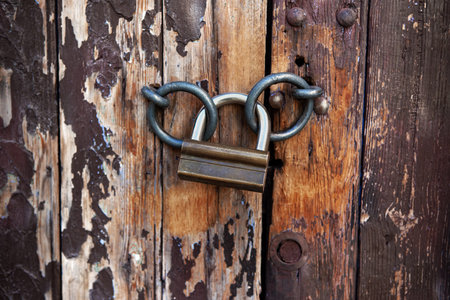 Close up of a padlock on an old door